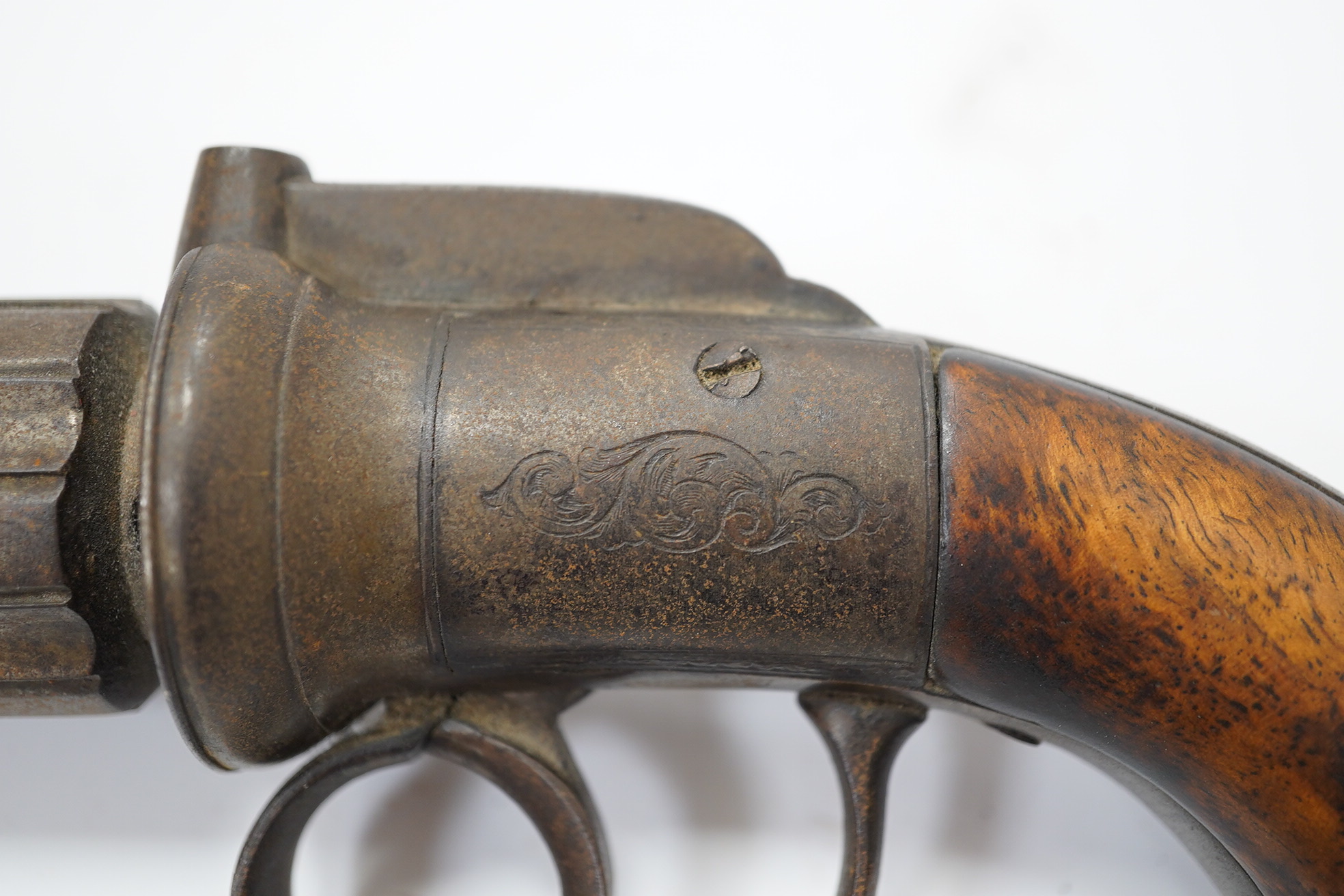 A six shot self-cocking percussion pepper box revolver, Birmingham proofs, foliate engraved round frame and two piece walnut grips, barrel 7cm. Condition - fair